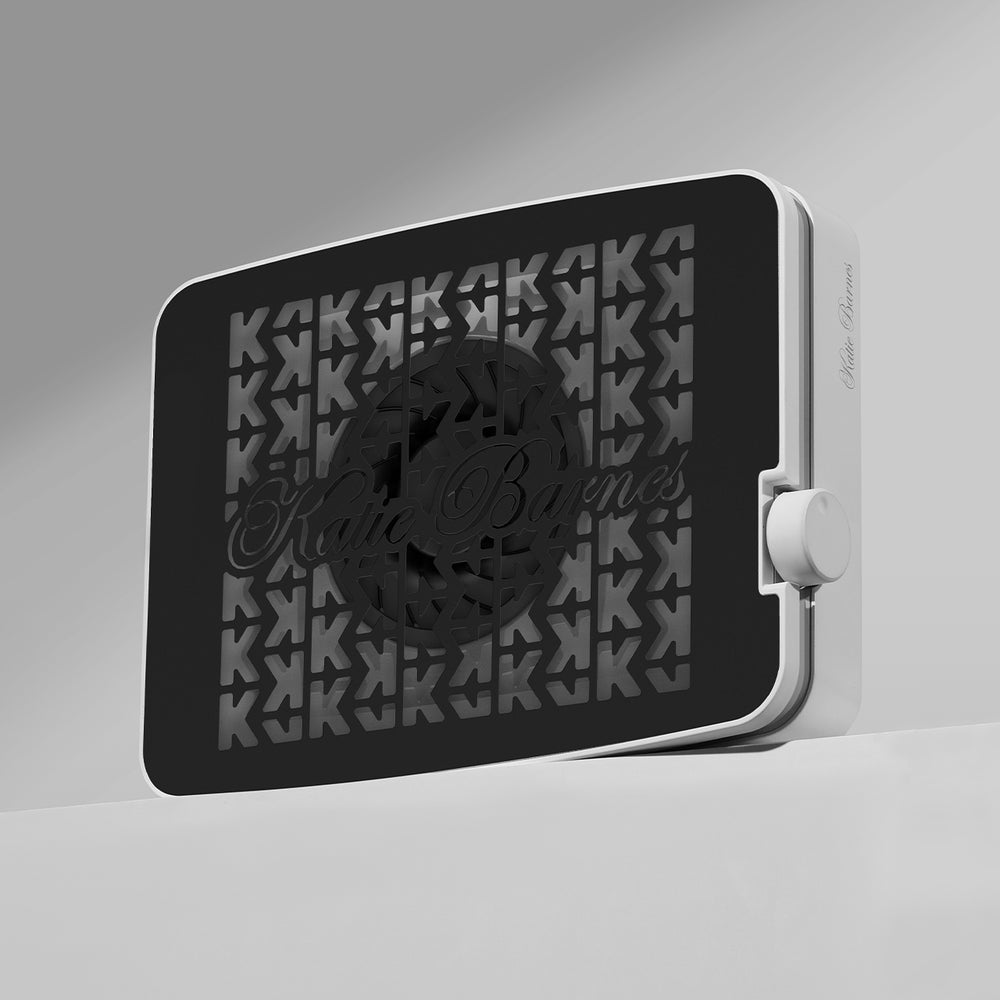 Katie Barnes Cordless Rechargeable Dust Collector with a black grill with the logo Katie Barnes